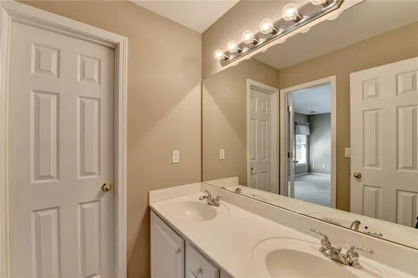 a bathroom with a double vanity sink and a mirror