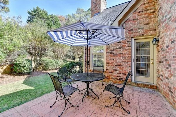 a patio with a yard table and chairs