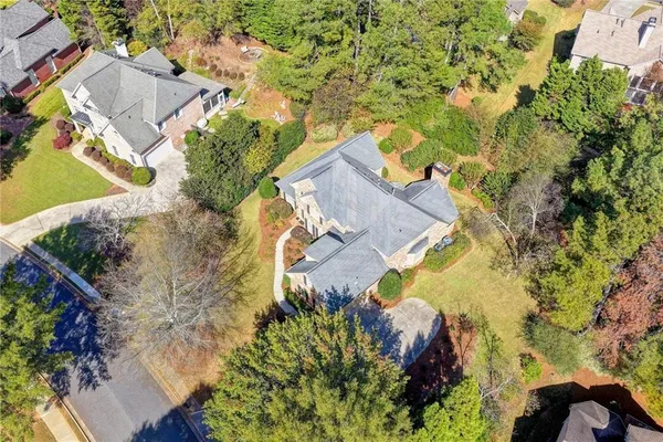 an aerial view of a house with a yard basket ball court and outdoor seating