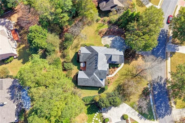 an aerial view of a house with a yard pool patio and outdoor seating