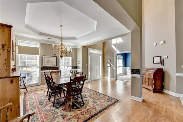 a view of a dining room with furniture and chandelier