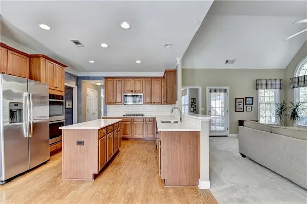 a large kitchen with stainless steel appliances lots of counter top space
