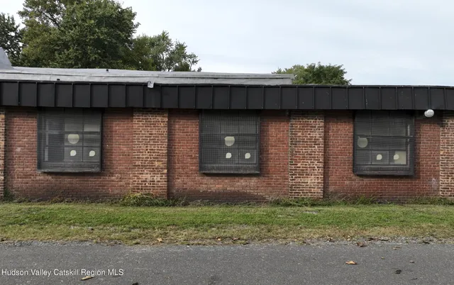 a brick building with a bench in front of it