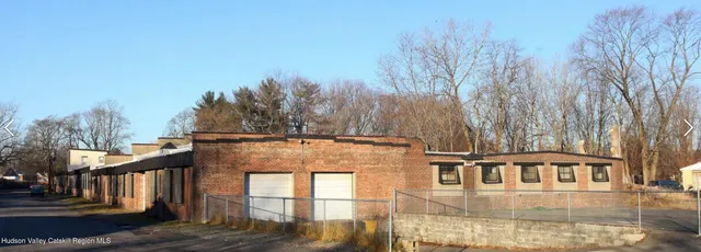 a view of a brick house with a yard