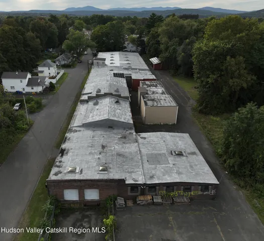 a room with a large window and furniture