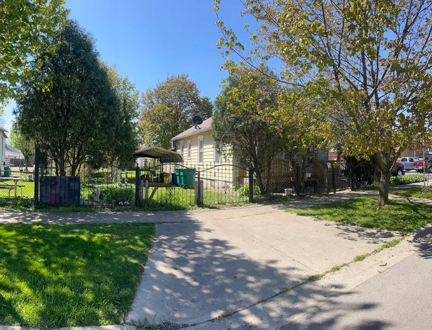 a front view of a house with a yard and outdoor seating