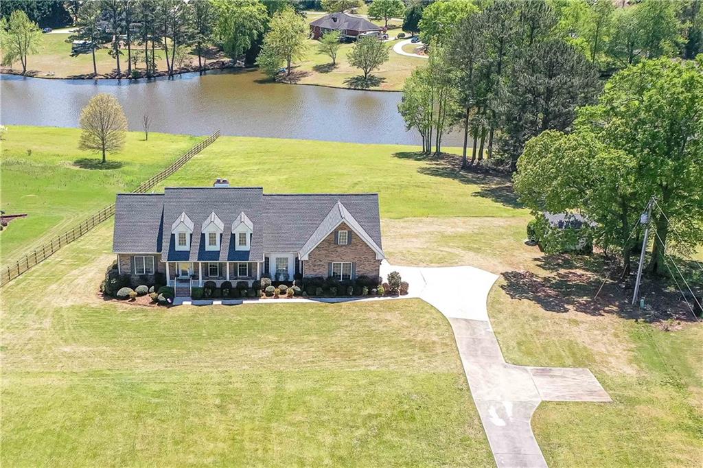 a view of a house with swimming pool and a yard
