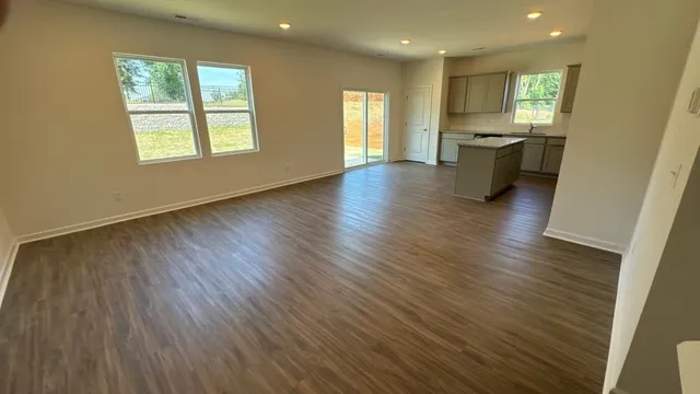 a view of livingroom and dining room with wooden floor and fan