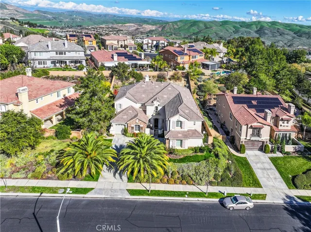 an aerial view of multiple houses with a yard