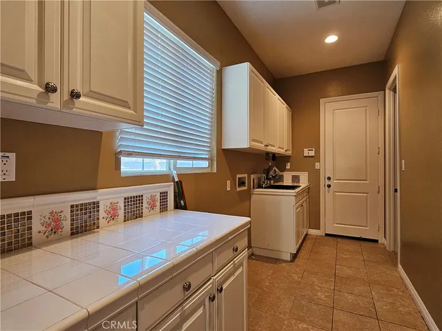 a large kitchen with stainless steel appliances granite countertop a lot of counter space and wooden floors