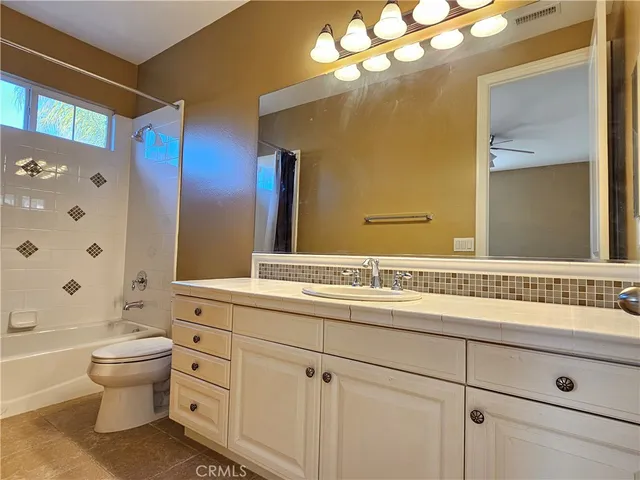 a kitchen that has a lot of cabinets in it and appliances