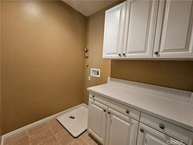 an empty room with windows and a ceiling fan