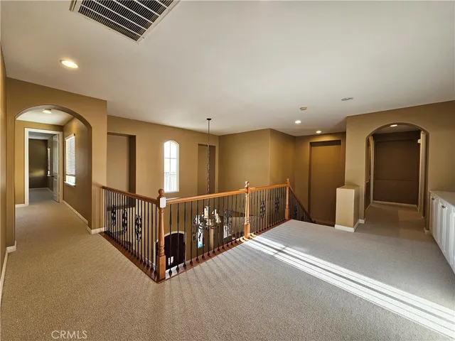 a spacious bathroom with a granite countertop sink a mirror a bathtub and shower