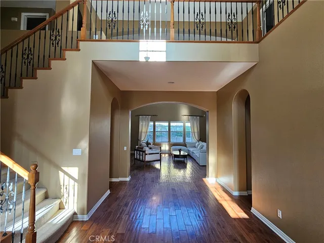 a view of a hallway view with wooden floor and staircase