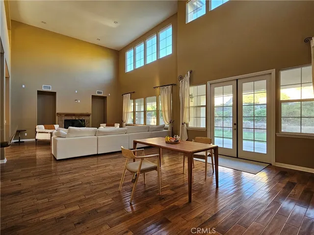 a living room with fireplace furniture and a wooden floor