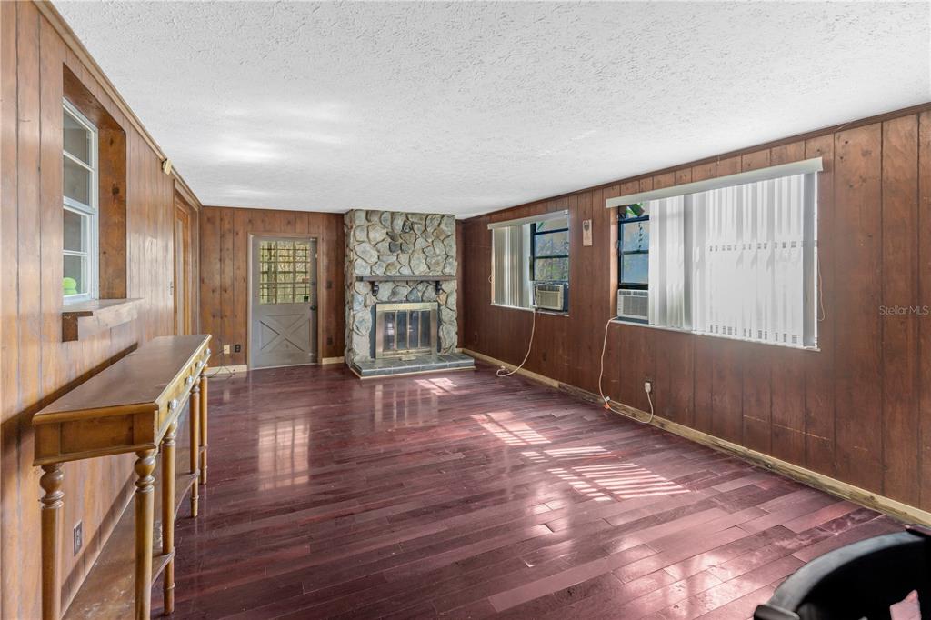 310 Kenmore Road Brandon, FL 33511 - Photo 13 of 33 a view of an empty room with wooden floor and a window