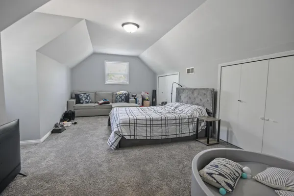 a bedroom with a bed and a couch