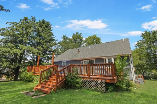 a view of a house with a yard and deck