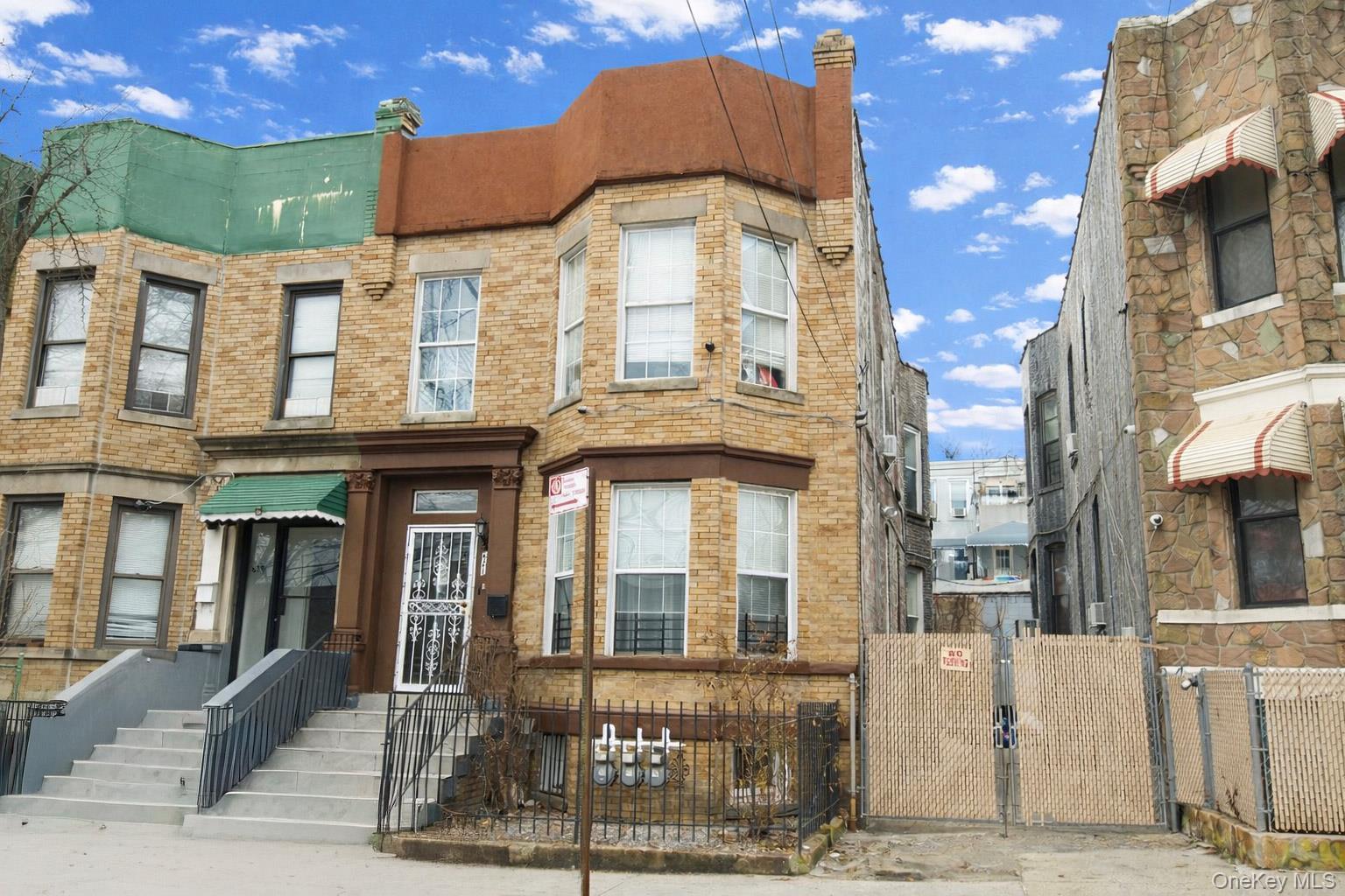 a front view of a residential apartment building with a yard
