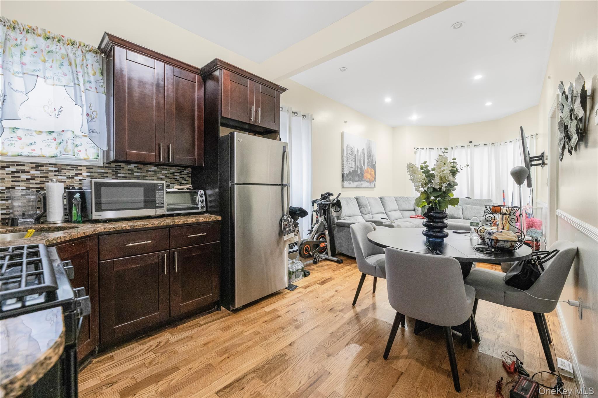 621 Faile Street Bronx, NY 10474 - Photo 13 of 32 a kitchen with a table chairs refrigerator and microwave
