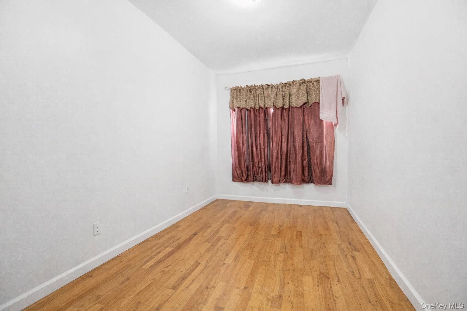 621 Faile Street Bronx, NY 10474 - Photo 26 of 32 a view of a room with wooden floor and a window
