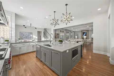 a large kitchen with stainless steel appliances granite countertop a large center island and a sink