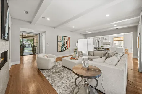a living room with fireplace furniture and a wooden floor