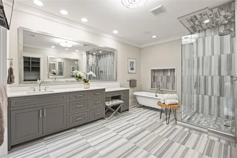 a spacious bathroom with a double vanity sink and a large mirror
