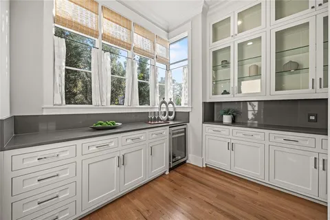 a kitchen with granite countertop white cabinets and a large window