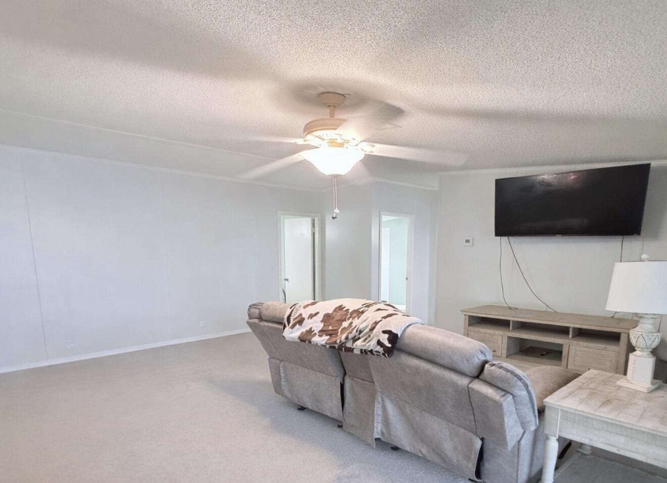 4096 Southwest 9th Way Okeechobee, FL 34974 - Photo 11 of 36 a living room with furniture and a flat screen tv