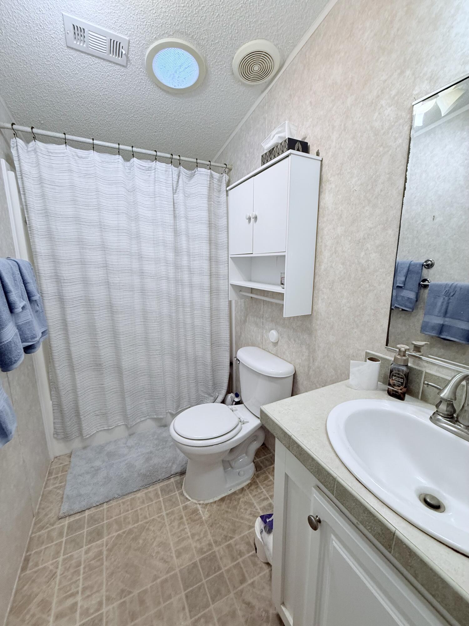 4096 Southwest 9th Way Okeechobee, FL 34974 - Photo 17 of 36 a bathroom with a sink toilet and shower