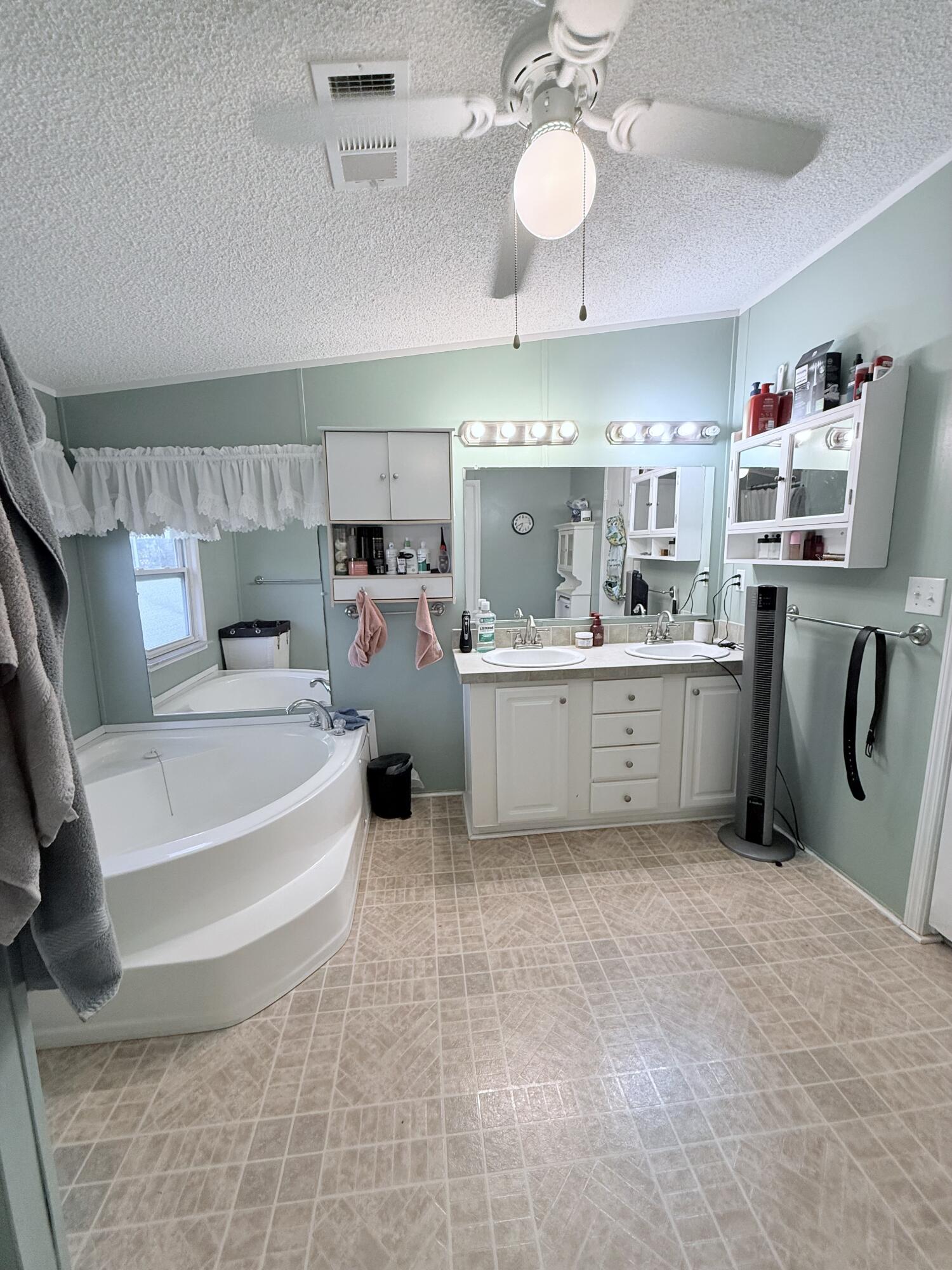 4096 Southwest 9th Way Okeechobee, FL 34974 - Photo 21 of 36 a large white kitchen with a white countertops a stove a sink and dishwasher