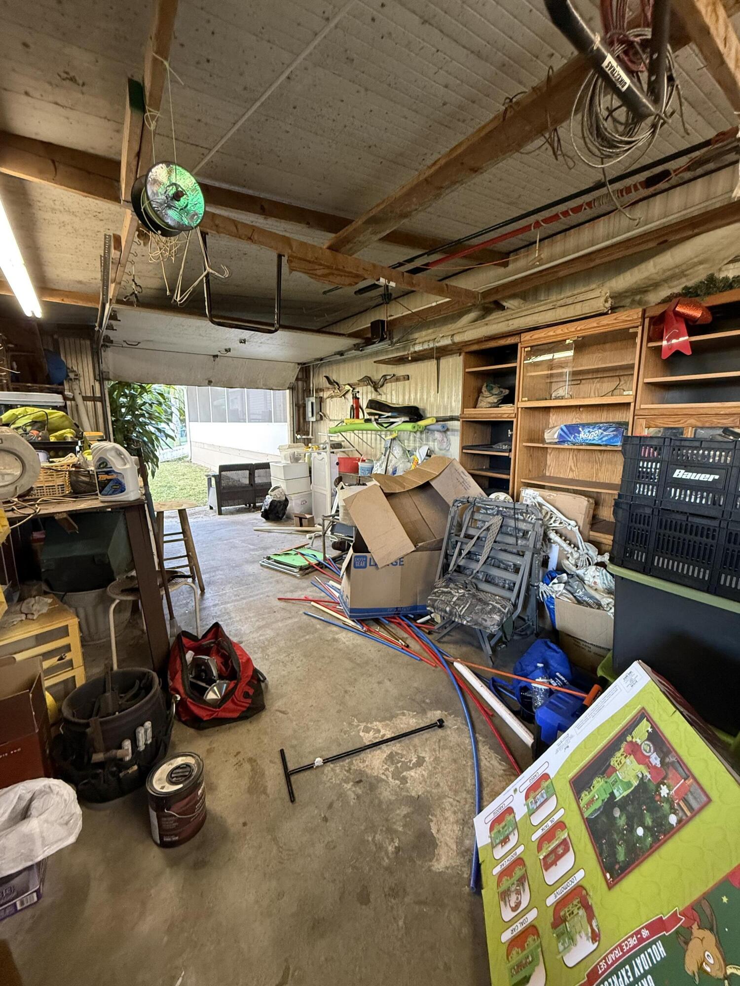 4096 Southwest 9th Way Okeechobee, FL 34974 - Photo 32 of 36 a storage room with lots of clutter and chairs