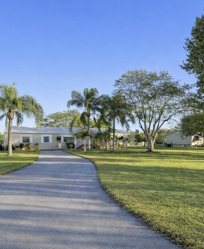 4096 Southwest 9th Way Okeechobee, FL 34974 - Photo 4 of 36 a view of swimming pool and trees in the background