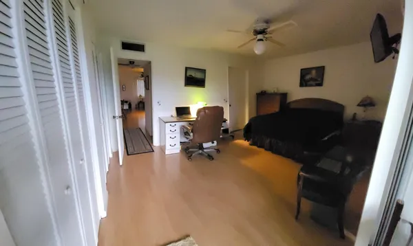 a view of a workspace with furniture and a window