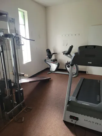 a room with gym equipment and a window