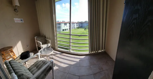 a view of a room with lounge chair and windows