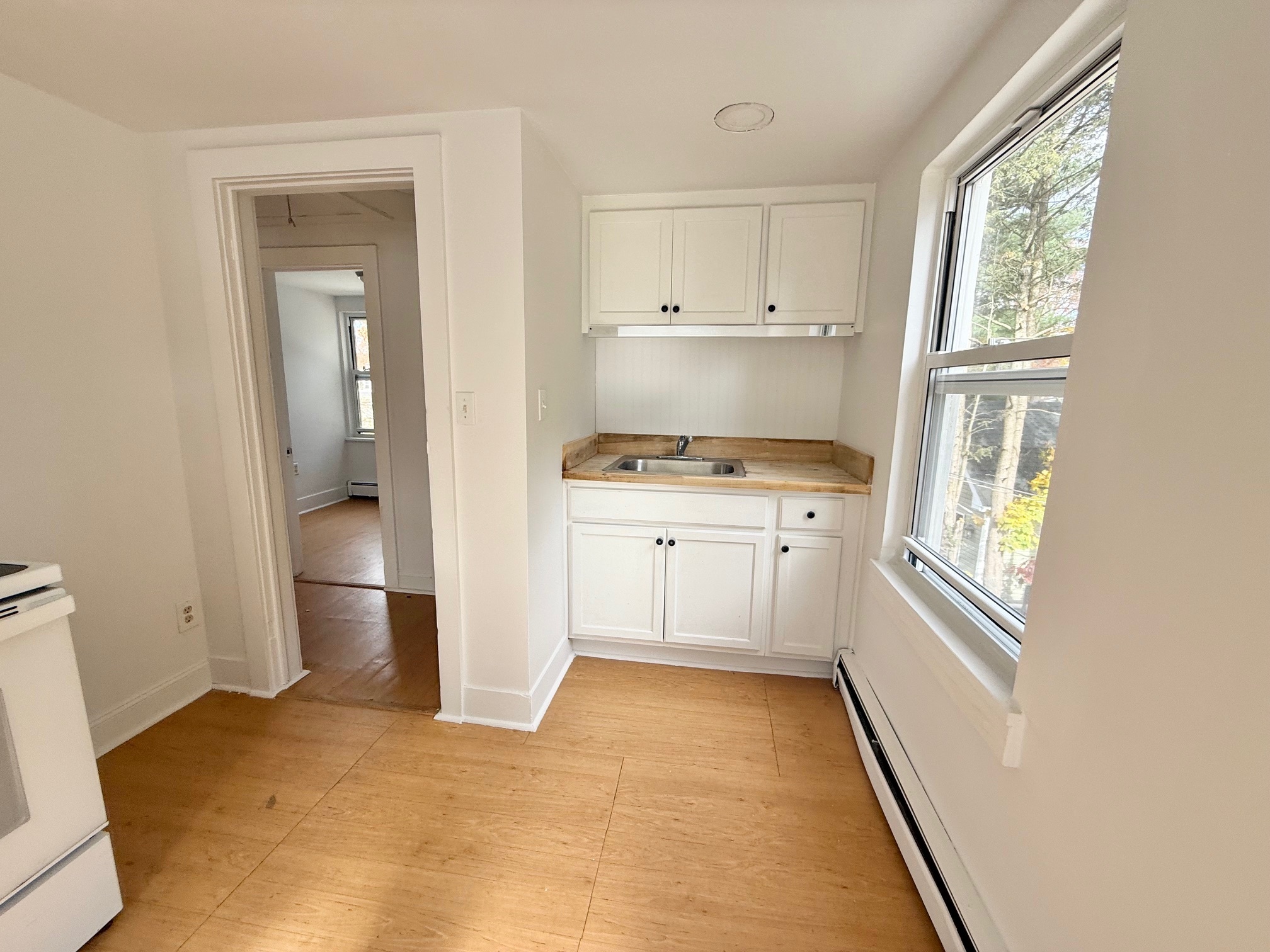 261 Hillside Avenue, Unit 2 Torrington, CT 06790 - Photo 7 of 10 a kitchen with a refrigerator and window