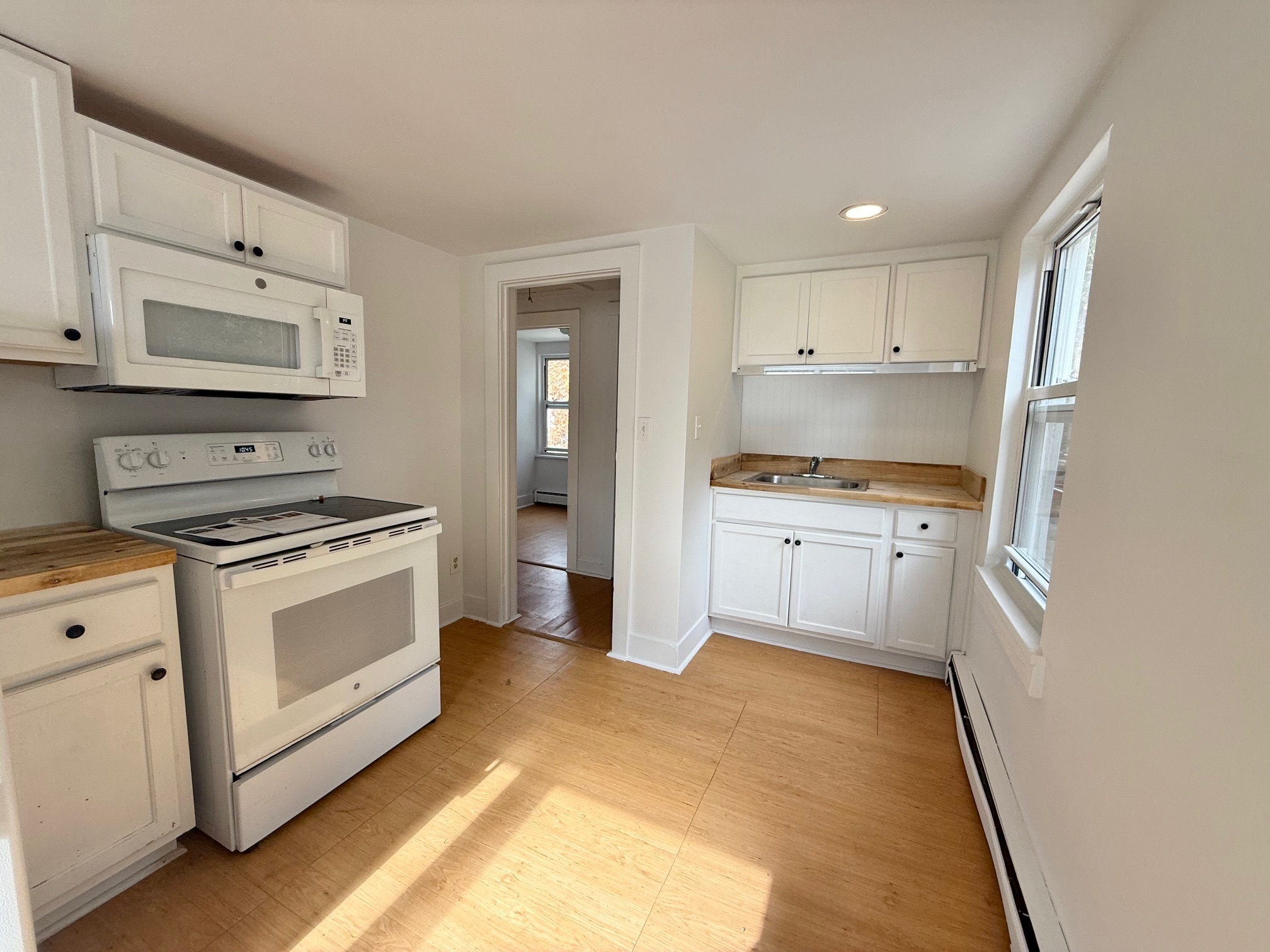 261 Hillside Avenue, Unit 2 Torrington, CT 06790 - Photo 8 of 10 a kitchen with white cabinets and appliances