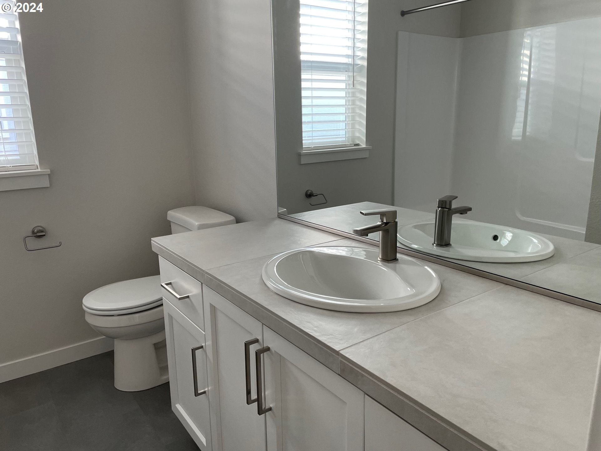 20629 Southwest Boyd Court, Unit 3 Beaverton, OR 97003 - Photo 12 of 46 a bathroom with a toilet sink and mirror
