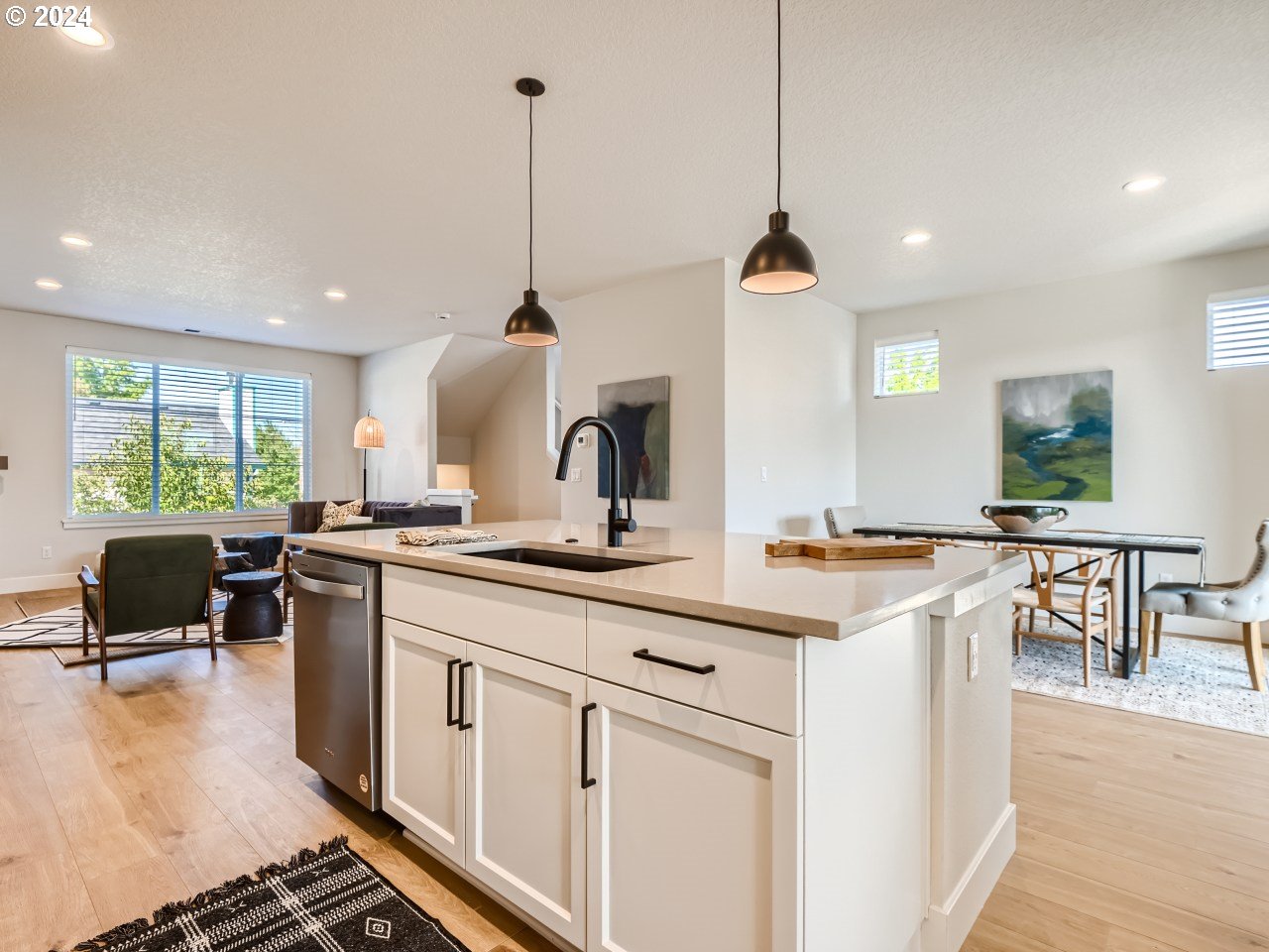 20629 Southwest Boyd Court, Unit 3 Beaverton, OR 97003 - Photo 26 of 46 a kitchen with stainless steel appliances granite countertop a stove a sink a oven a dining table with white cabinets and wooden floor