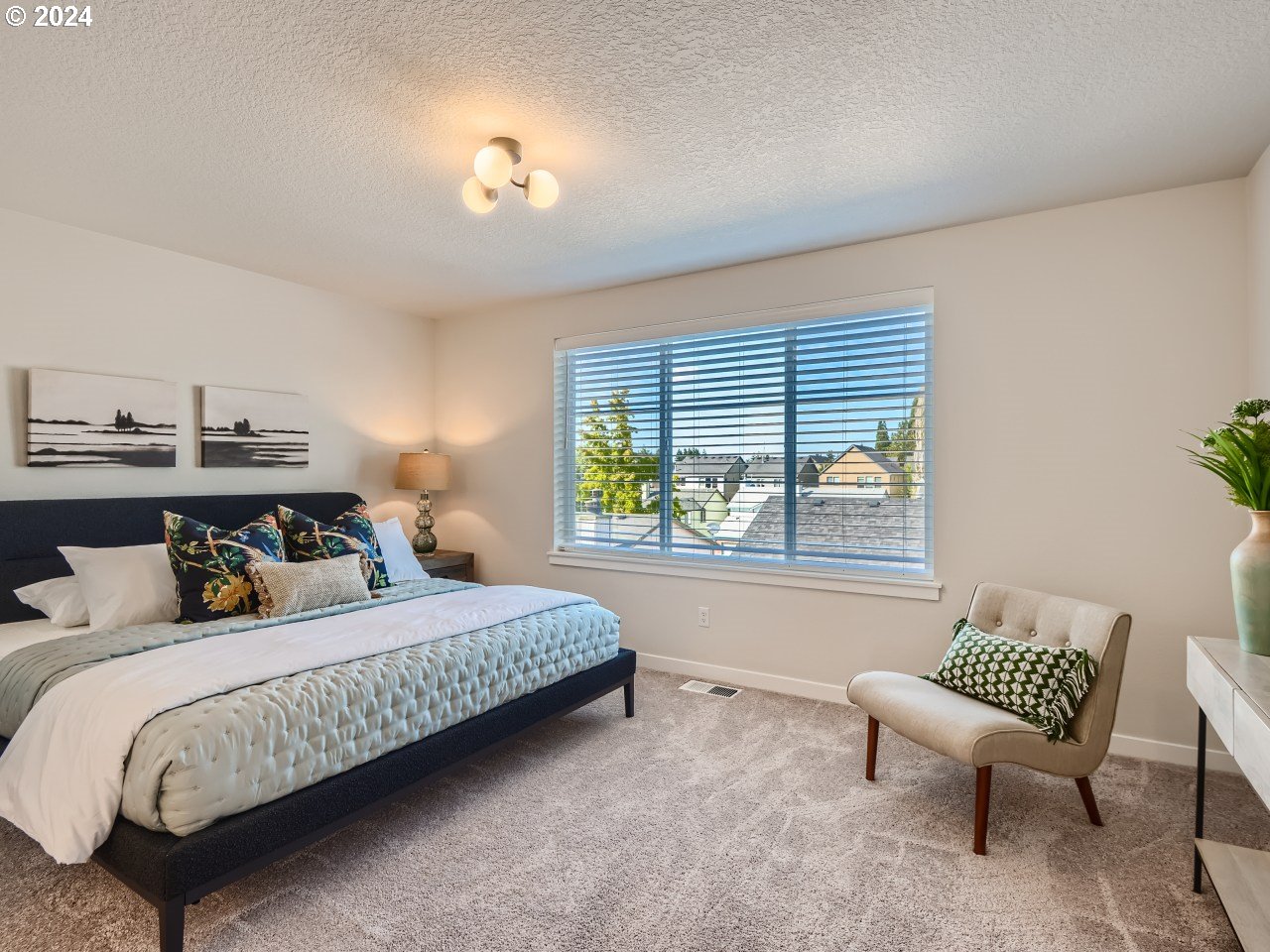 20629 Southwest Boyd Court, Unit 3 Beaverton, OR 97003 - Photo 30 of 46 a bedroom with a bed and a chair