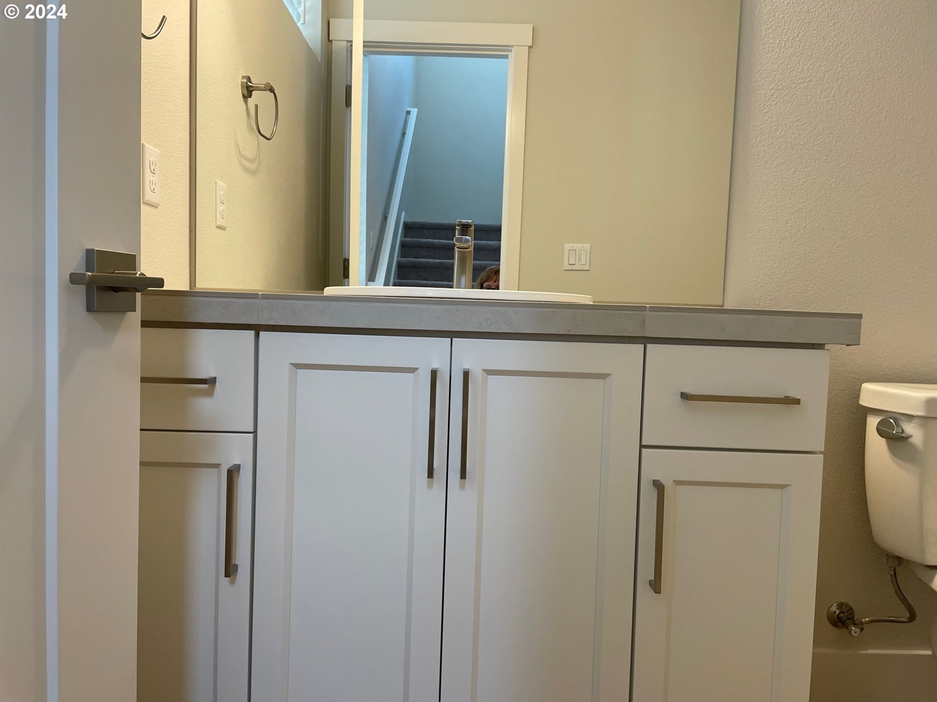 20629 Southwest Boyd Court, Unit 3 Beaverton, OR 97003 - Photo 9 of 46 a bathroom with a sink a toilet and mirror