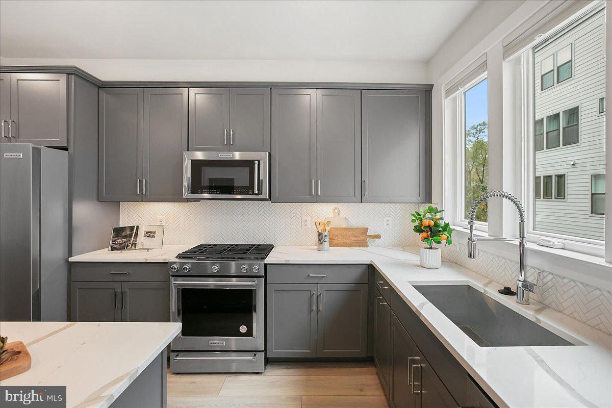 12768 Sunrise Valley Drive Reston, VA 20191 - Photo 10 of 33 a kitchen with a sink stove and microwave
