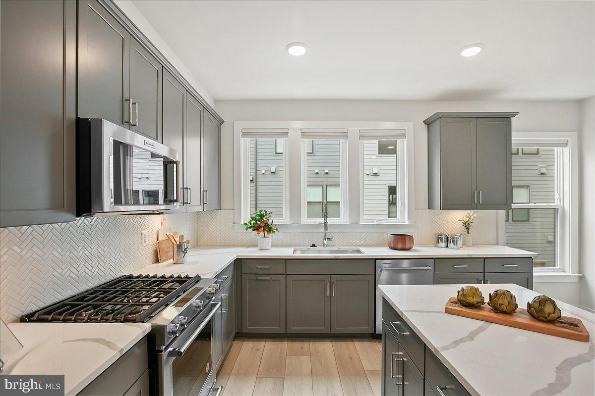 12768 Sunrise Valley Drive Reston, VA 20191 - Photo 12 of 33 a kitchen that has a sink and a stove in it