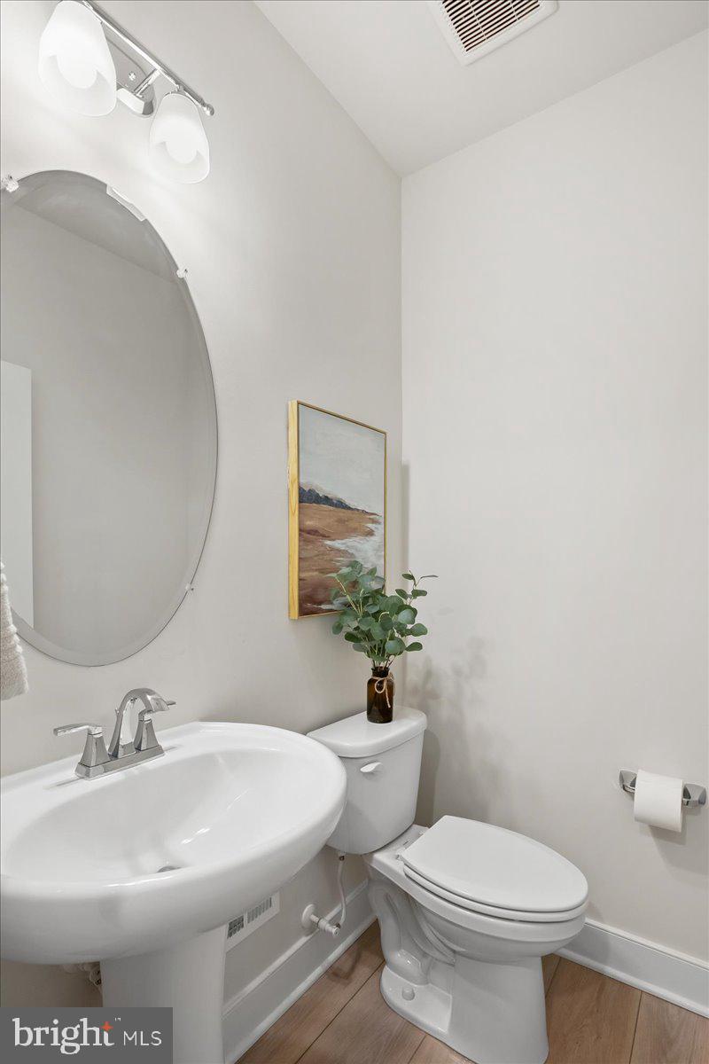 12768 Sunrise Valley Drive Reston, VA 20191 - Photo 13 of 33 a bathroom with a sink toilet and mirror