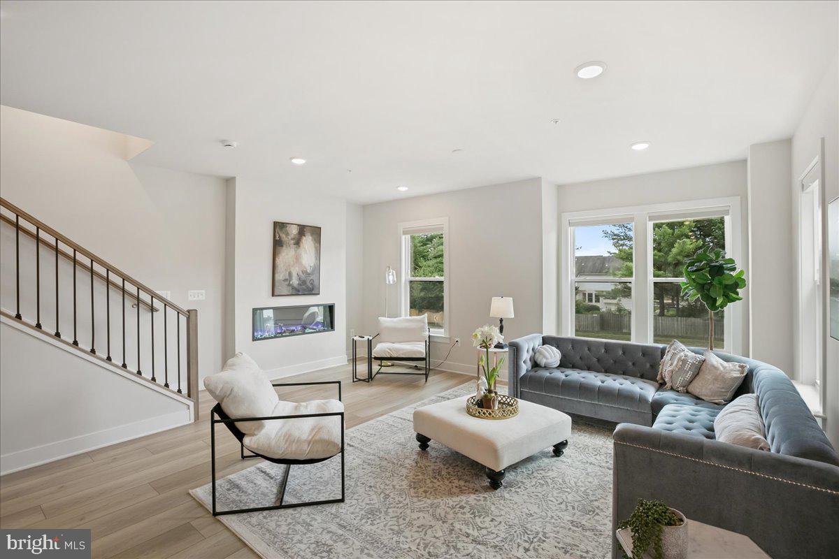 12768 Sunrise Valley Drive Reston, VA 20191 - Photo 16 of 33 a living room with furniture and a large window