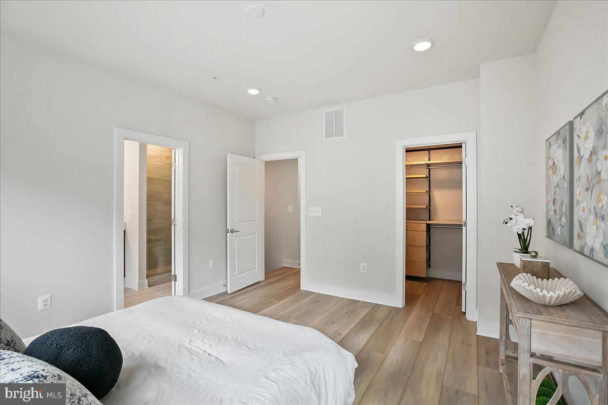 12768 Sunrise Valley Drive Reston, VA 20191 - Photo 19 of 33 a bedroom with a bed and a dresser