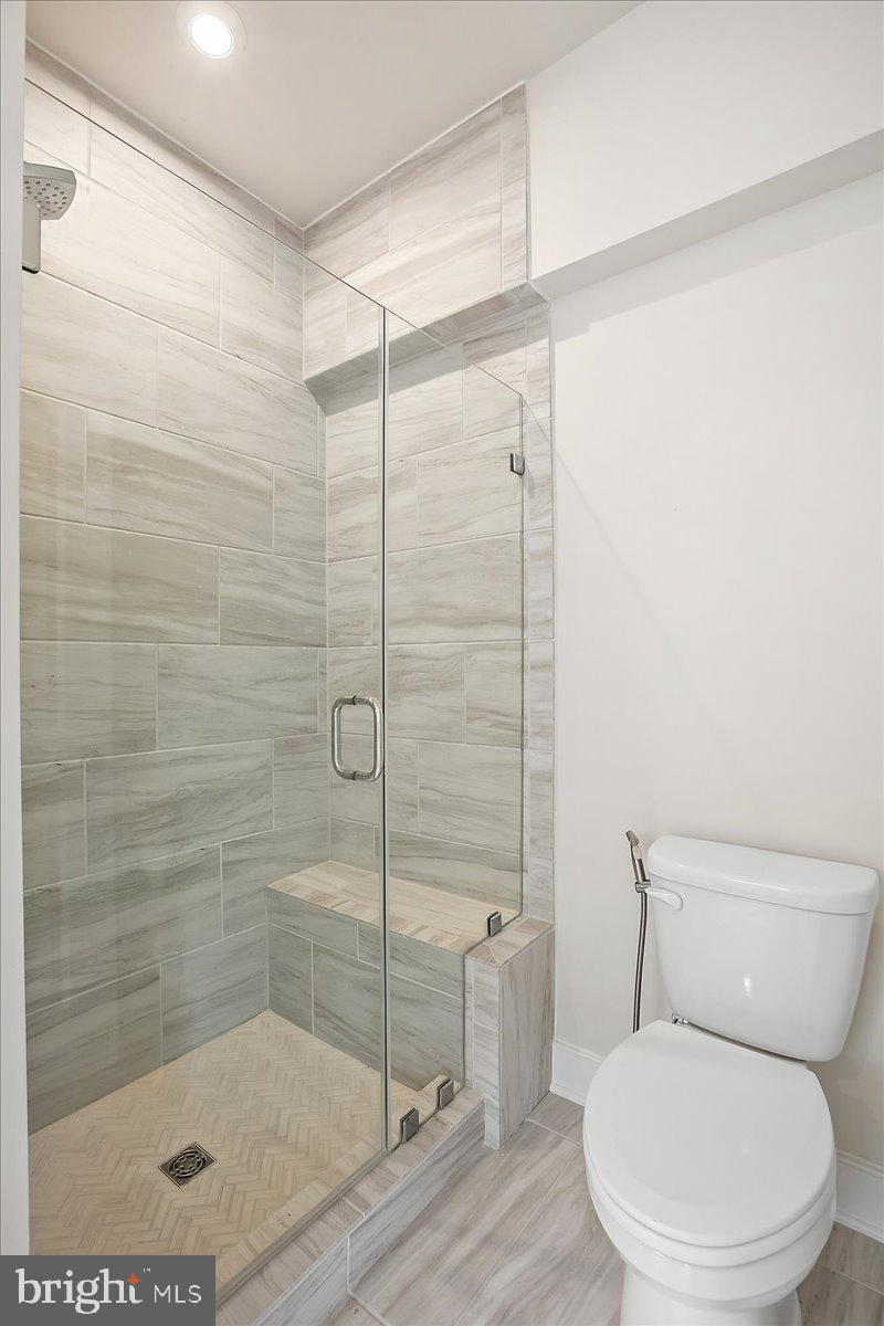 12768 Sunrise Valley Drive Reston, VA 20191 - Photo 20 of 33 a white toilet sitting next to a bath tub and shower