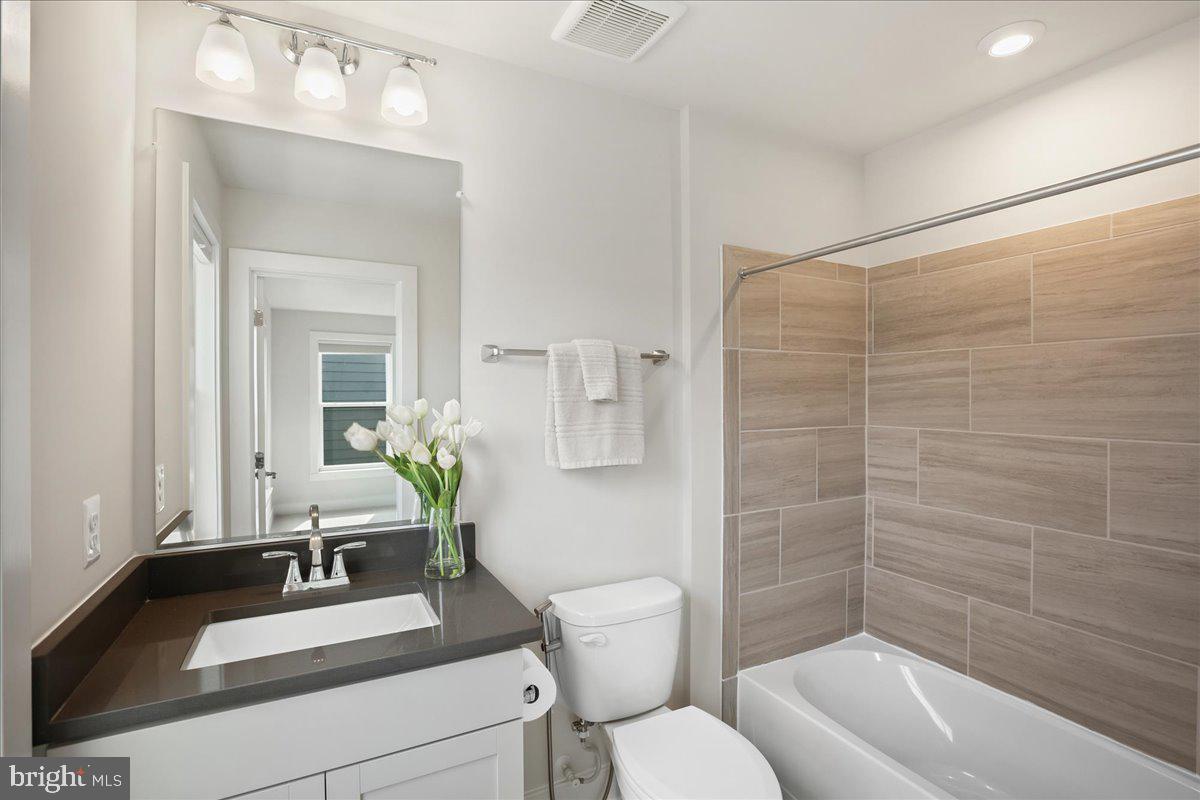 12768 Sunrise Valley Drive Reston, VA 20191 - Photo 28 of 33 a bathroom with a sink a toilet and shower